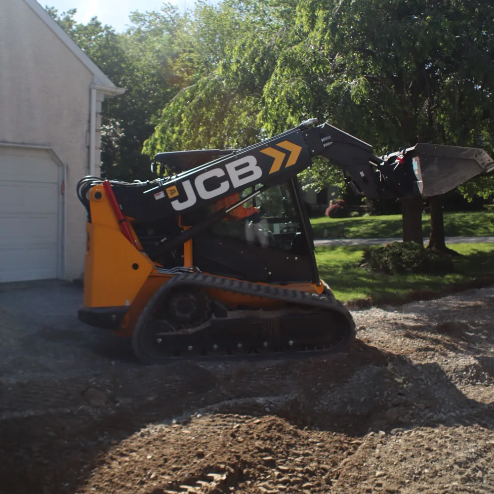 Compact construction equipment performing site work